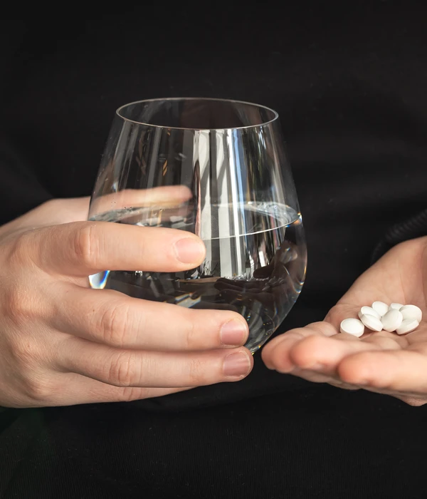 twilight-prescription-drug-person-holding-glass-water-pills-page